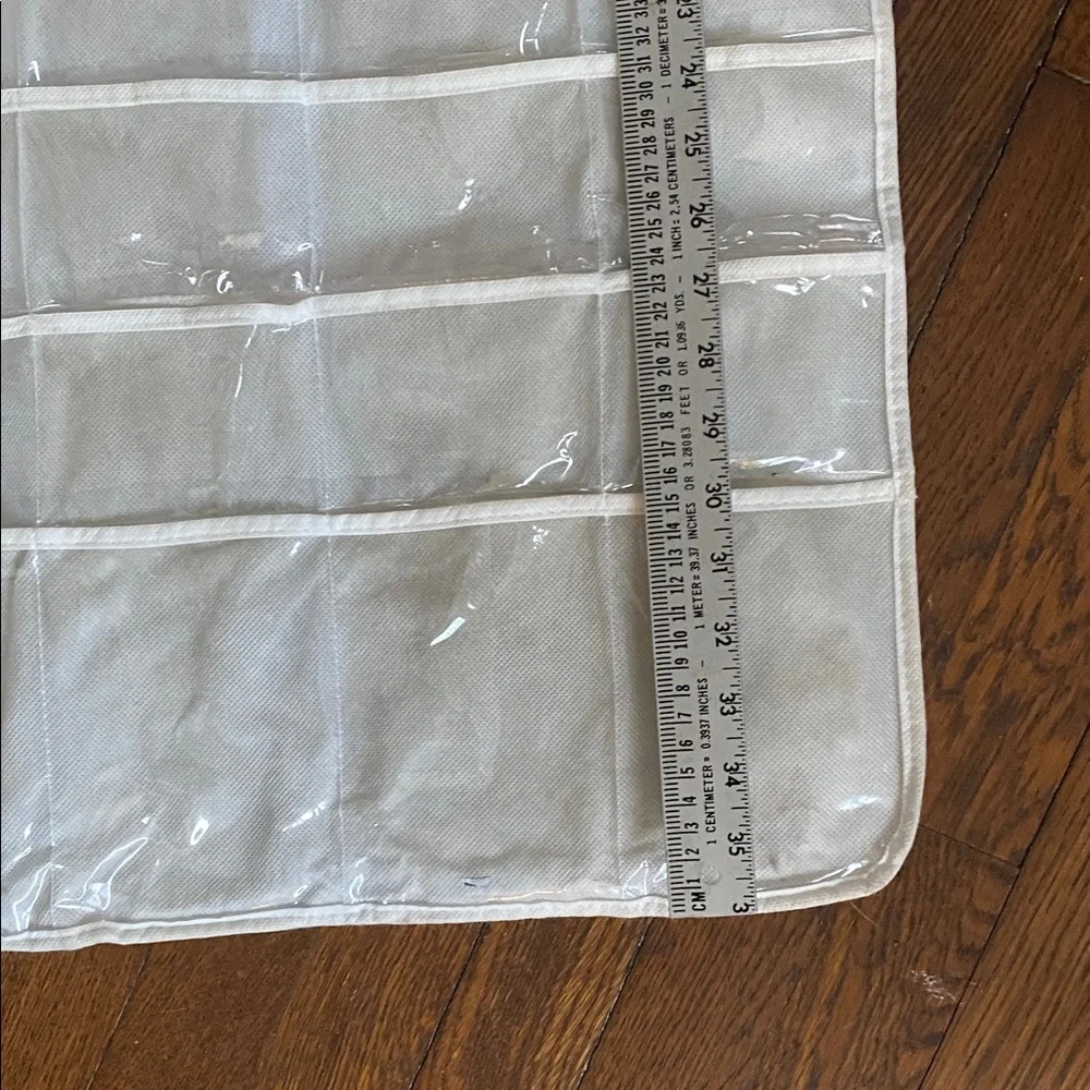 Double-Sided Jewelry Organizer with 80 Clear Pockets hangs in closet